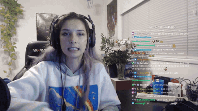 a woman wearing headphones is on a twitch channel with a sub goal of 205/20