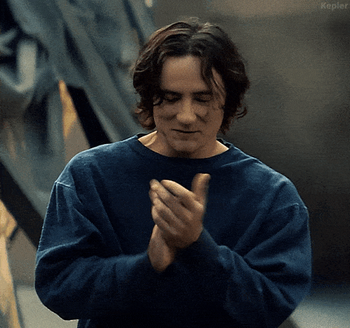 a man wearing a blue shirt is clapping his hands and the word kepler is visible in the corner