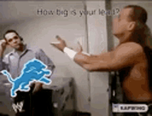 two men are standing next to each other in a room and one of them has a picture of a lion on his chest .
