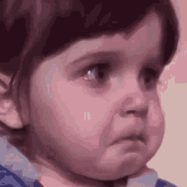 a little girl is making a funny face with her mouth open .