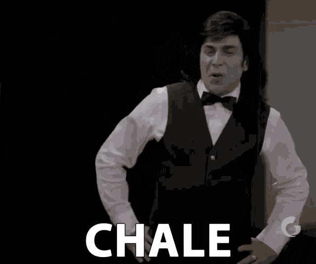 a man in a tuxedo and bow tie says chale in white letters