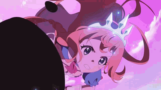 a girl with a crown on her head is looking up