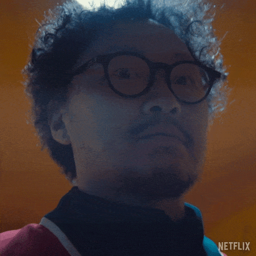 a close up of a man 's face with a netflix logo on the bottom right