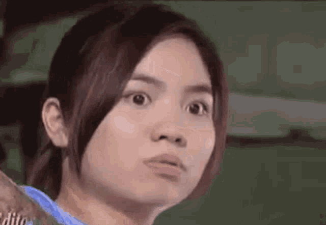 a close up of a woman making a funny face with her eyes closed .