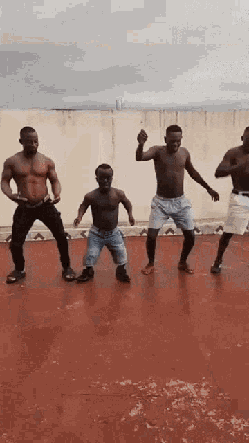 a group of men dancing on a red floor