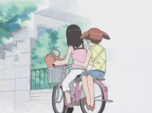 two girls are riding a pink bicycle with a basket on the back