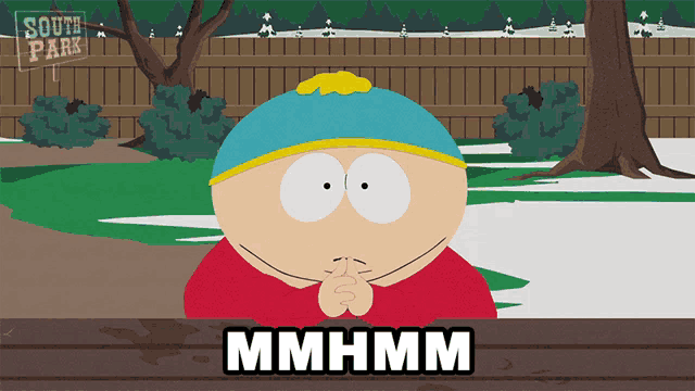 a cartoon character from south park is sitting at a wooden table