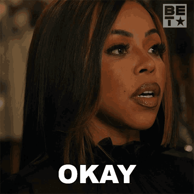 a close up of a woman 's face with the word okay in the corner