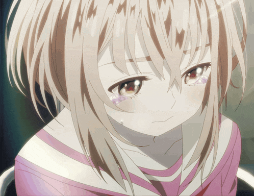 a close up of a girl with tears on her face
