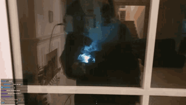 a reflection of a person smoking a cigarette in a window with the words " always your house " on the bottom