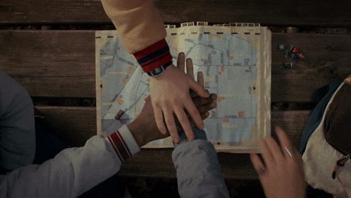two people putting their hands on top of a map that says ' washington ' on the top
