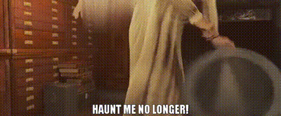 a person in a white robe is standing in a room with the words `` haunt me no longer '' .