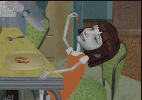 a girl in an orange dress is sitting at a table with a plate of food on it