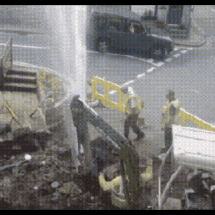 a man in a yellow vest is standing next to a yellow barrier that says ' a ' on it