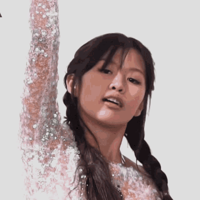 a close up of a woman 's face with her arms outstretched