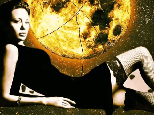 a woman in a black dress and fishnet stockings is laying in front of a burning sun