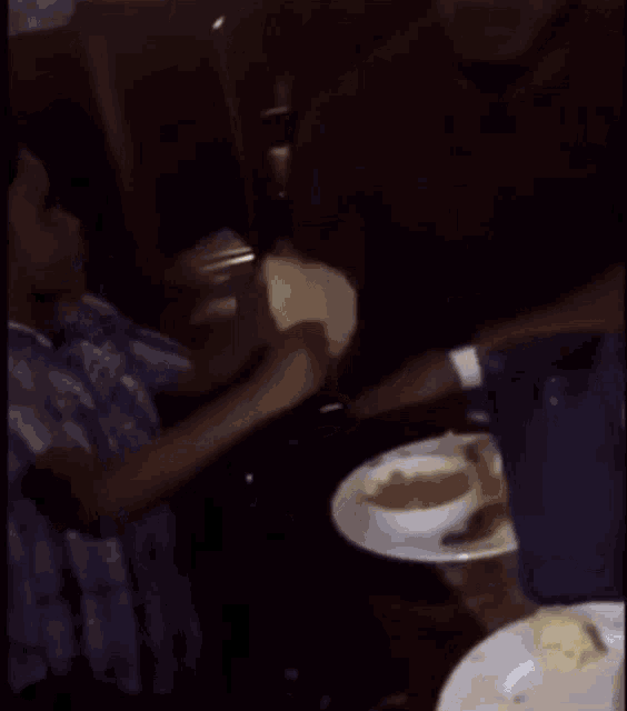 a man is sitting at a table with a plate of food