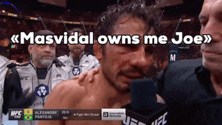 a man is crying in front of a microphone with the words masvidal owns me joe
