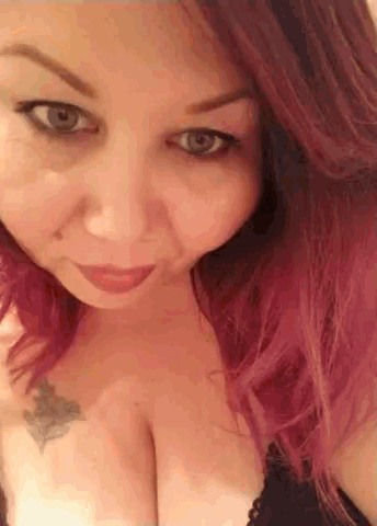 a close up of a woman 's face with red hair