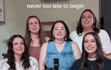 a group of young women are singing into microphones .