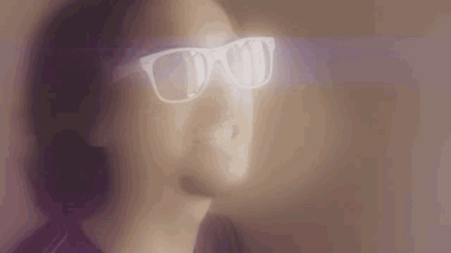 a blurry picture of a man wearing sunglasses