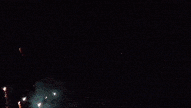 a dark background with a few lights shining through it