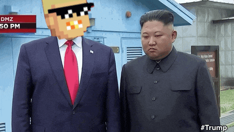 a man in a suit and tie stands next to a man in a pixelated costume