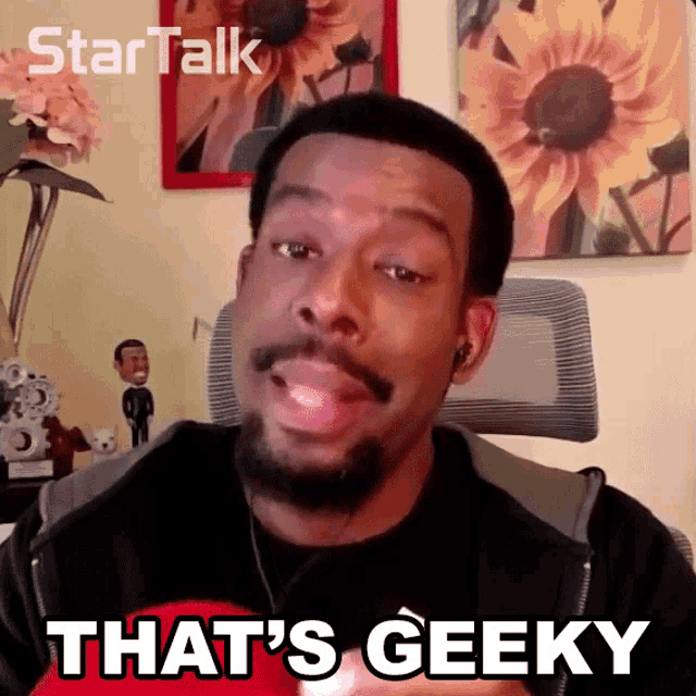 a man says " that 's geeky " while wearing headphones