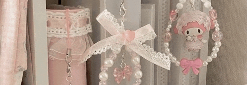 a close up of a shelf with a bunch of necklaces hanging from it .