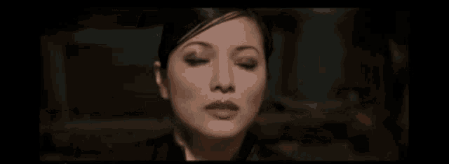 a close up of a woman 's face with tears running down her face .