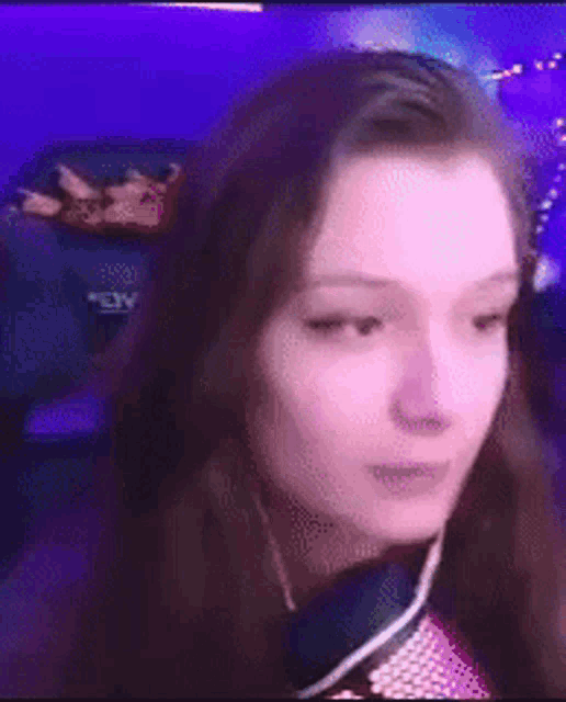 a woman is sitting in front of a microphone and making a face .