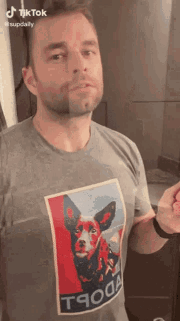 a man is wearing a t-shirt with a dog on it