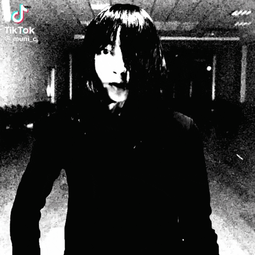 a black and white photo of a woman with a tik tok logo on the bottom