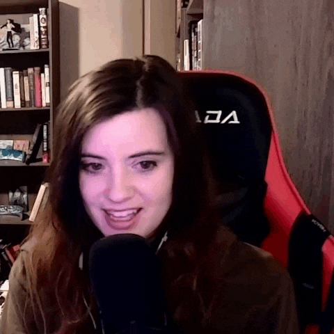 a woman is sitting in a red and black chair with the letter a on it