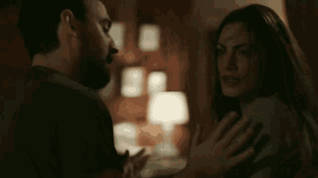 a man and a woman are dancing together in a dark room .