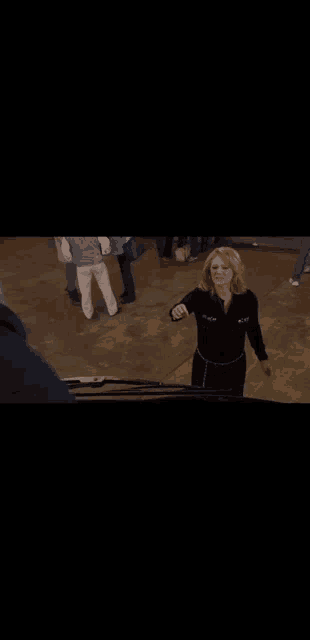 a person is playing a violin in a dark room .