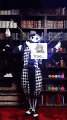 a clown is holding a sign that says true on it