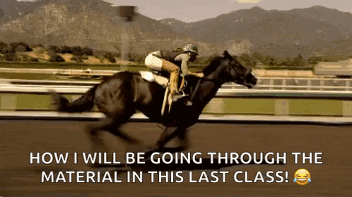 a jockey is riding a black horse on a race track .