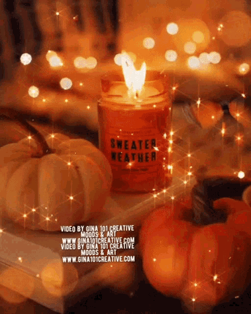 a candle that says sweater weather sits on a table with pumpkins