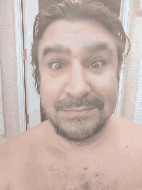 a man without a shirt is making a funny face