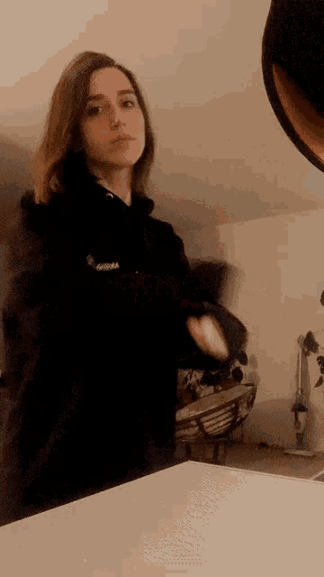 a woman in a black hoodie with the word gorilla on the sleeve