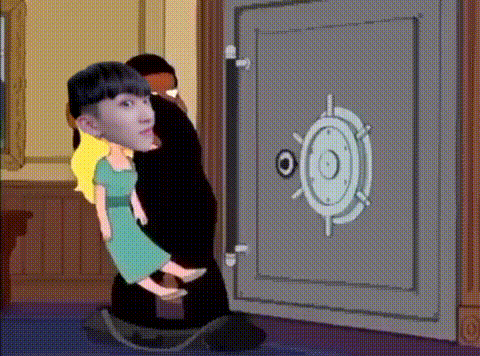 a man is holding a doll in front of a safe door .