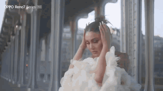 a woman in a white dress with the word oppo reno7 series on the bottom