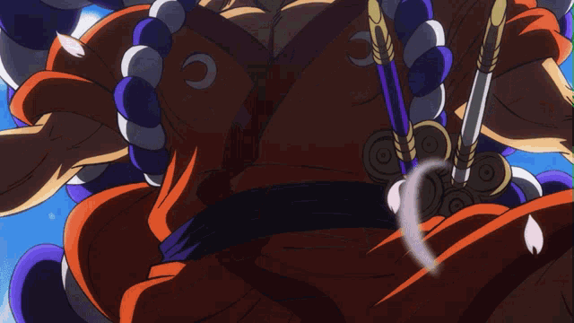 a man in a kimono is holding a pair of swords in his right hand