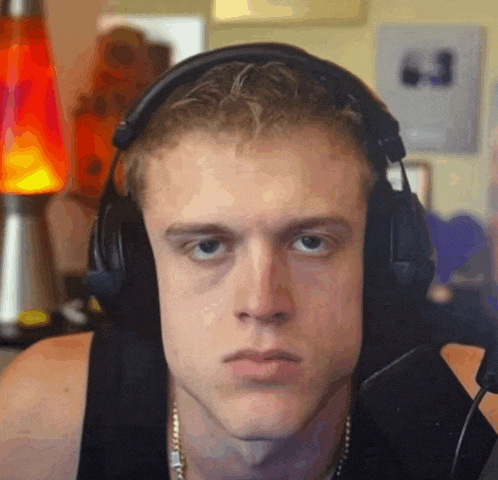 a close up of a man wearing headphones and a microphone