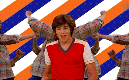 a man in a red and white shirt is surrounded by people dancing