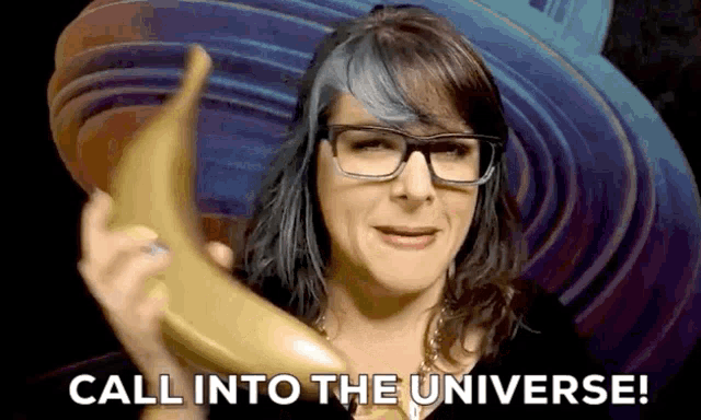 a woman with glasses is holding a banana and saying call into the universe .