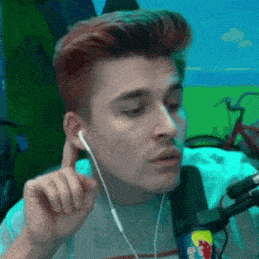 a man with red hair is wearing ear buds