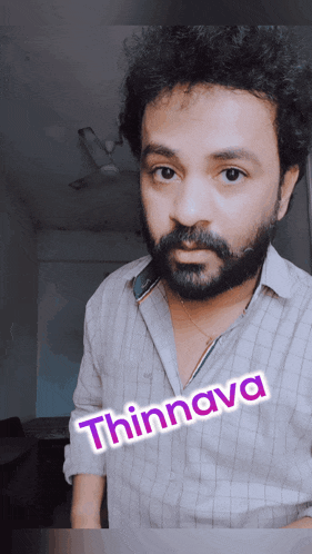 a man with a beard and a shirt that says thinnava