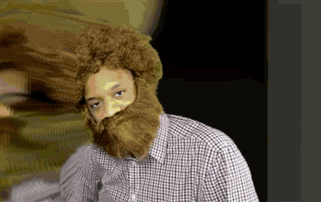 a man in a plaid shirt has a fake beard